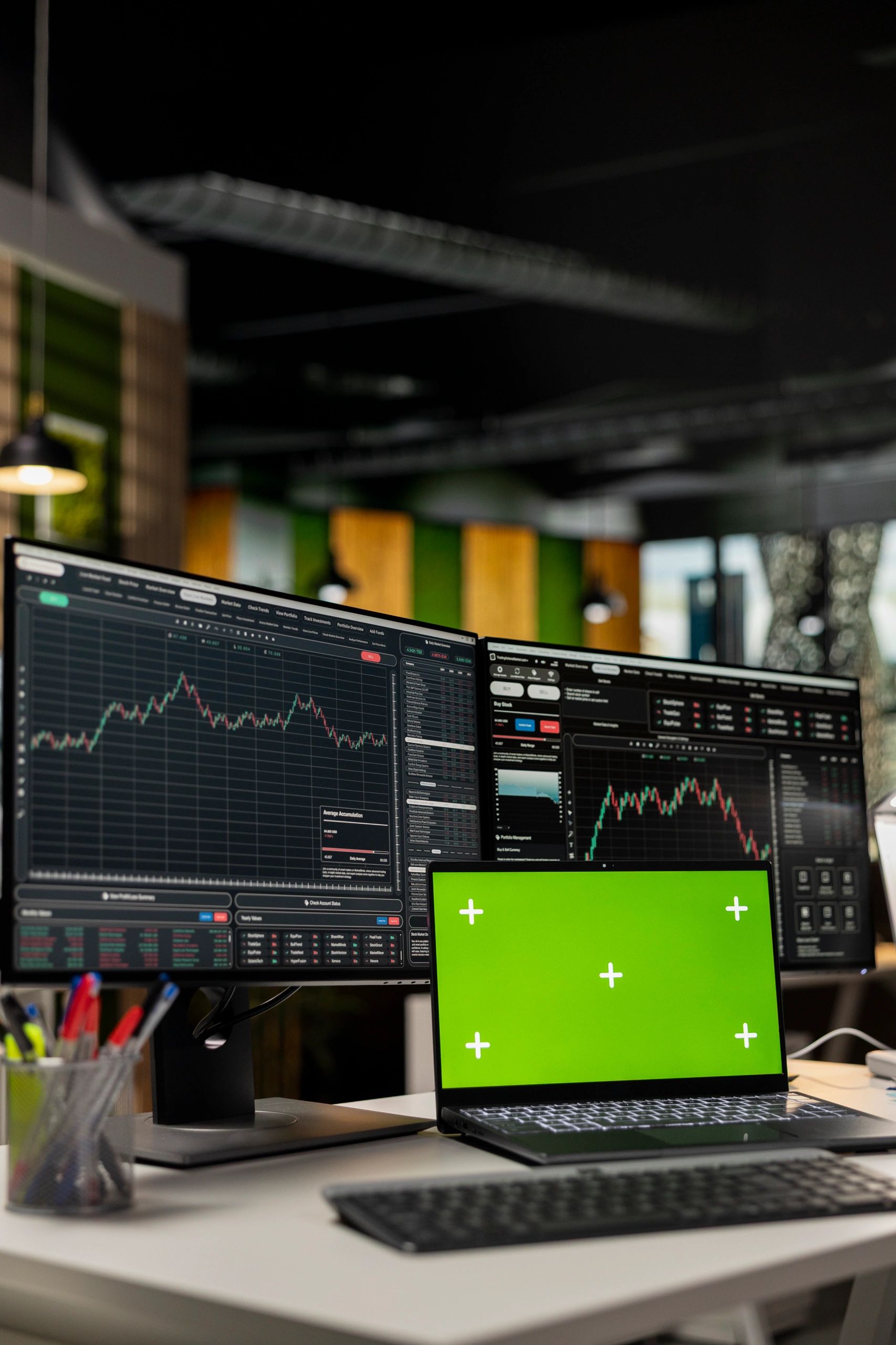 Screens showing market charts on a desk